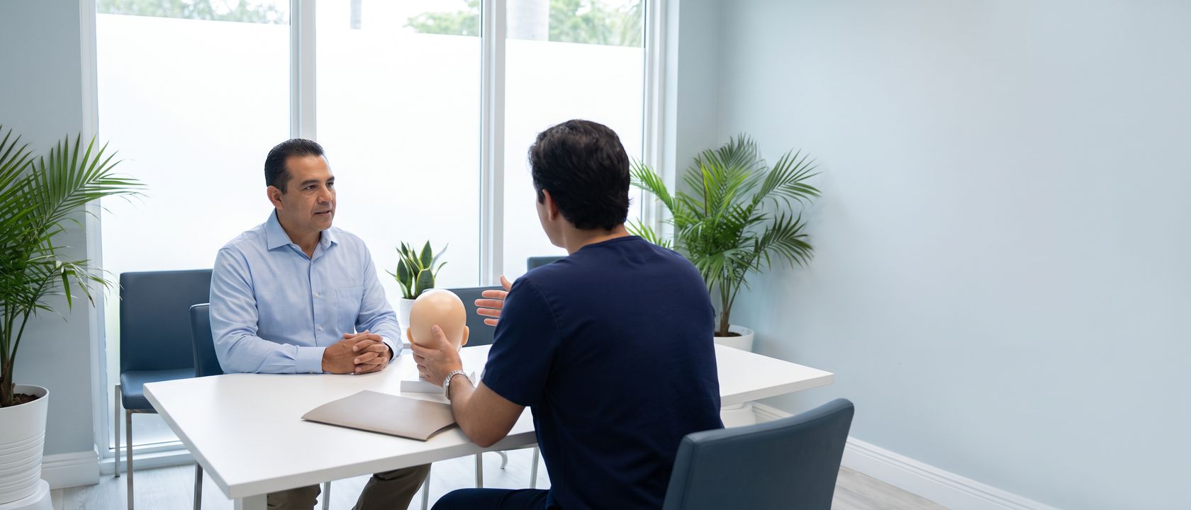 Hair transplant consultation with a scalp model