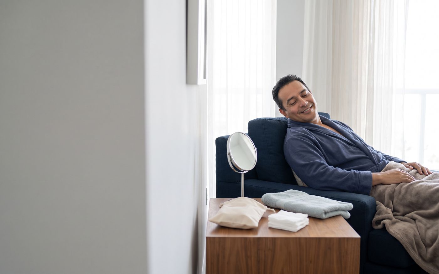 Patient resting at home with an aftercare kit during hair transplant recovery