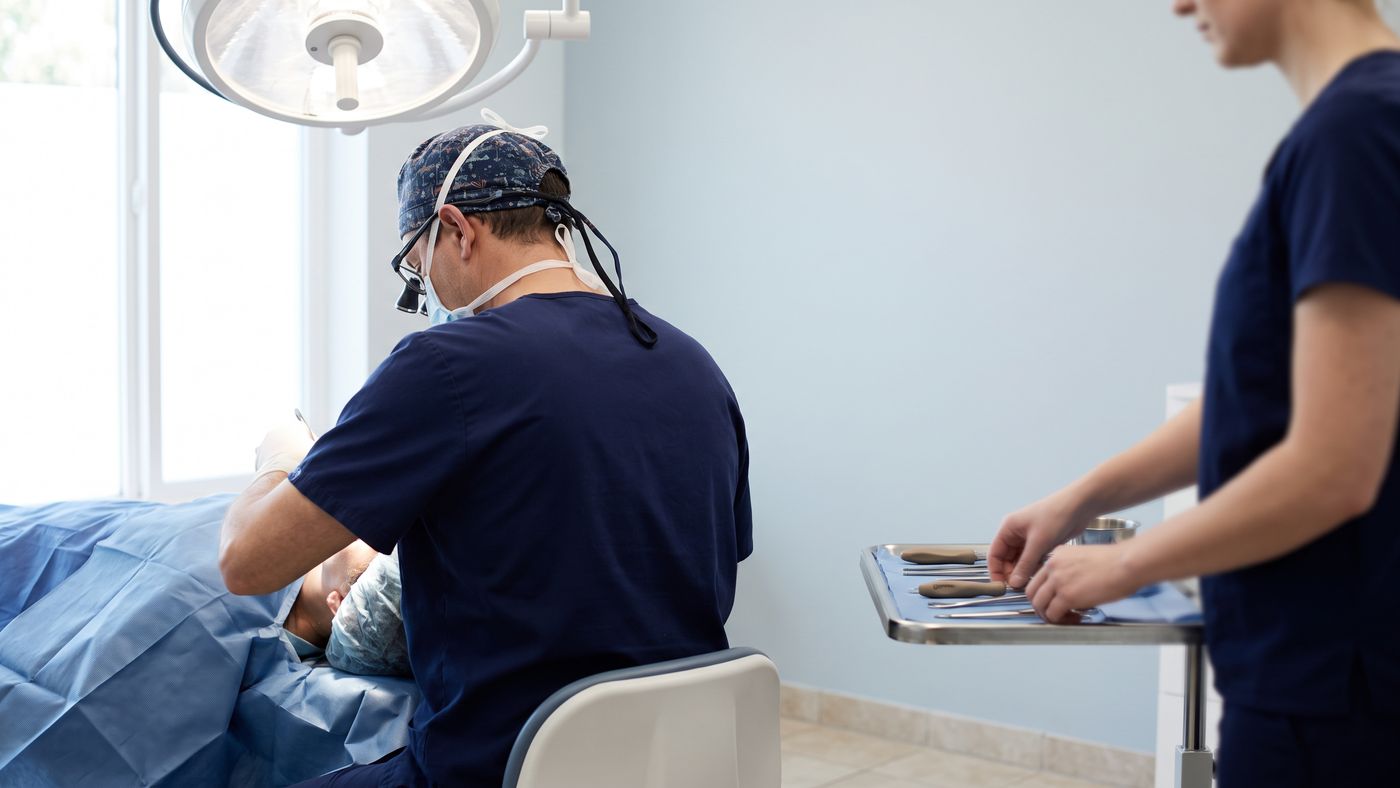 Surgeon and assistant preparing for a procedure